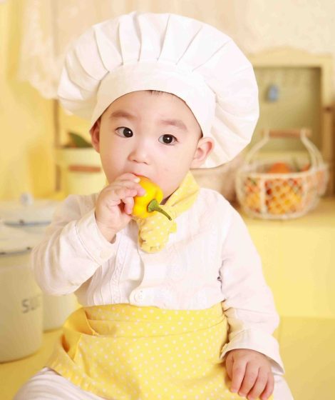 Toddler eating vegetable