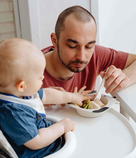 Dad feeding toddler